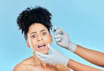 Filler, portrait of scared woman with hands on face in studio for collagen skincare consultation. Model with stress, fear and anxiety for beauty, dermatology or cosmetic process on blue background.