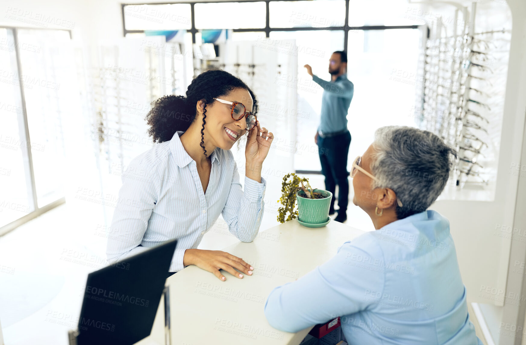 Buy stock photo Optometry, consulting or happy woman with glasses for vision in a retail optical or eyewear store. Shopping, talking or biracial customer with new spectacles or senior optometrist at optics clinic