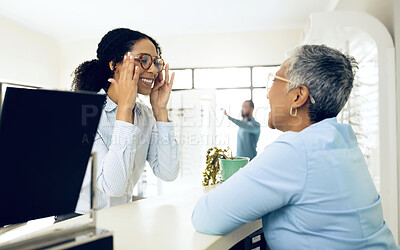 Buy stock photo Optometrist, glasses and woman for customer service, eye care support and advice for lens or frame choice in store. Happy client with vision, eyes health and doctor by counter talking, check and test