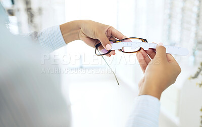 Buy stock photo Eye care, hands measure lens and frame of glasses, person in optometry clinic with test and healthcare. Eyewear, wellness and prescription with health, spectacles and optometrist with ruler tools