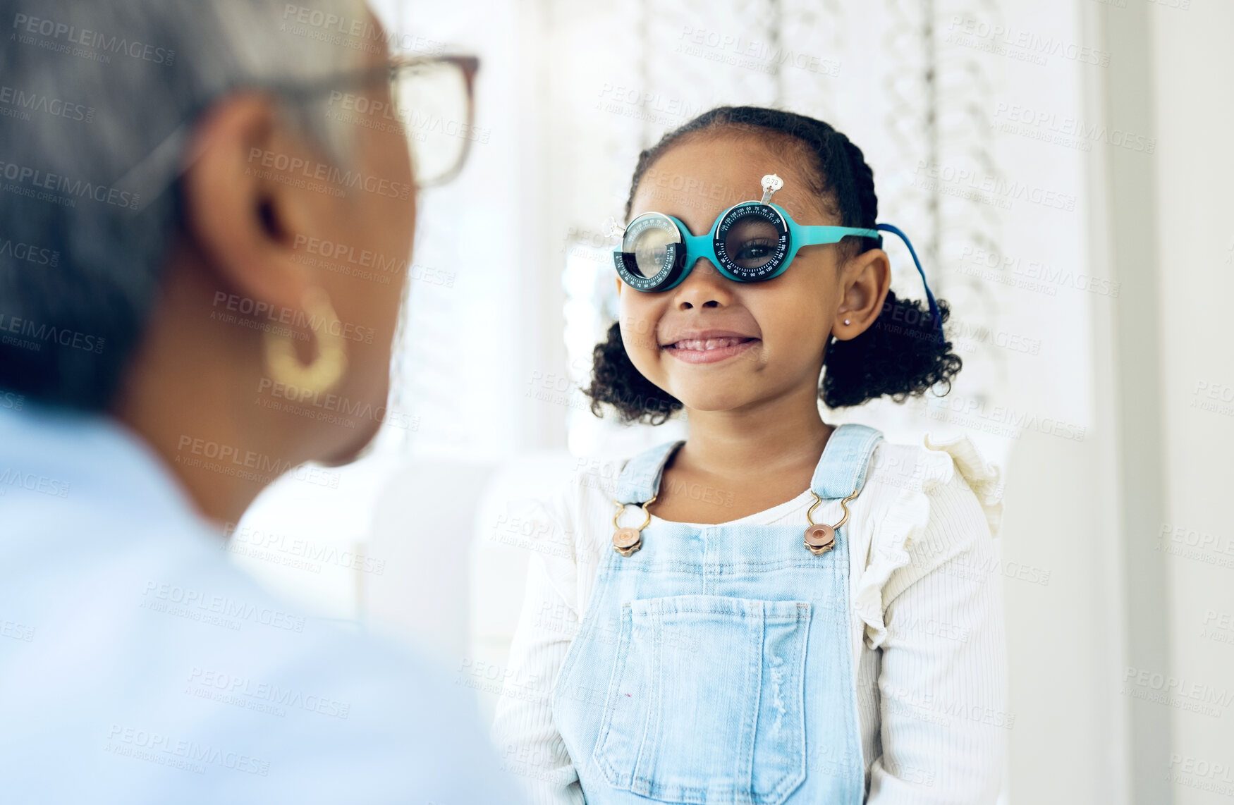 Buy stock photo Vision, glasses or eye test with a girl and optician in an eyewear store for prescription frame lenses. Medical, consulting or spectacles with a young child and woman optometrist in an office