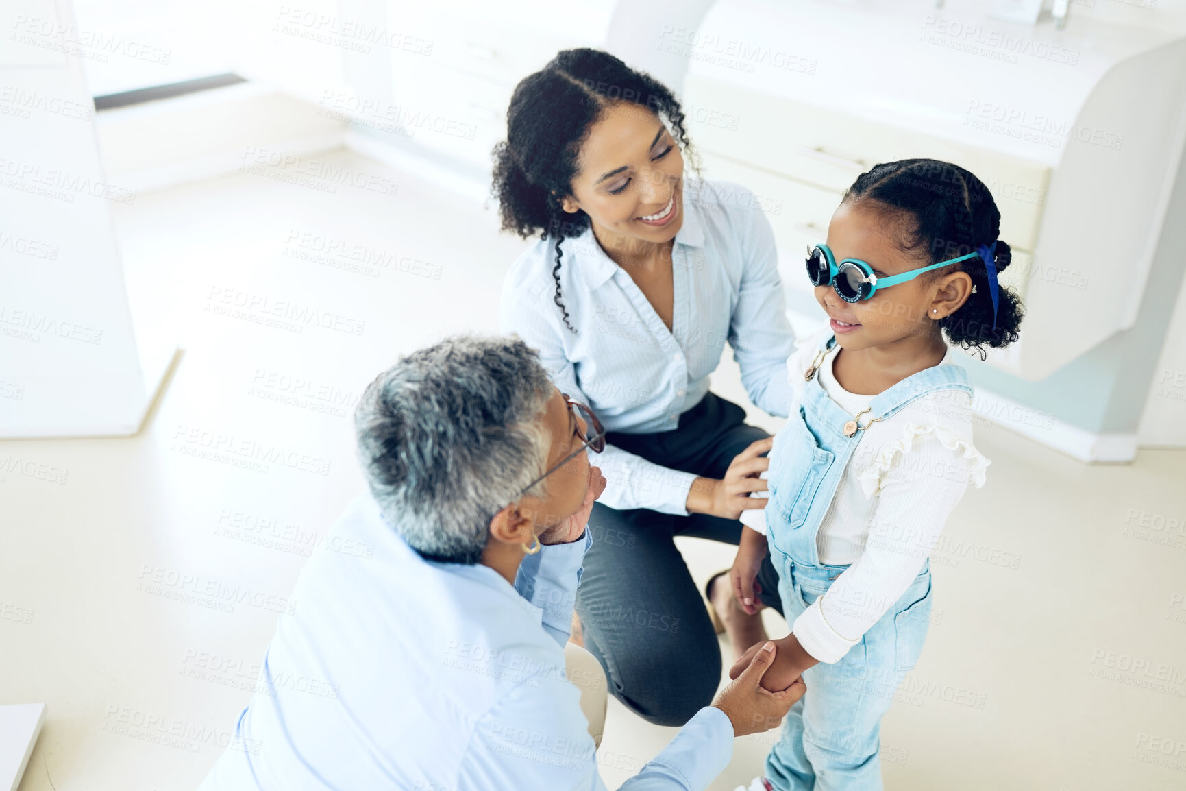 Buy stock photo Optometry, glasses and optometrist with child and mother at an eye care appointment for test. Health, wellness and senior optician with young mom and girl kid patient with lenses in an optical clinic