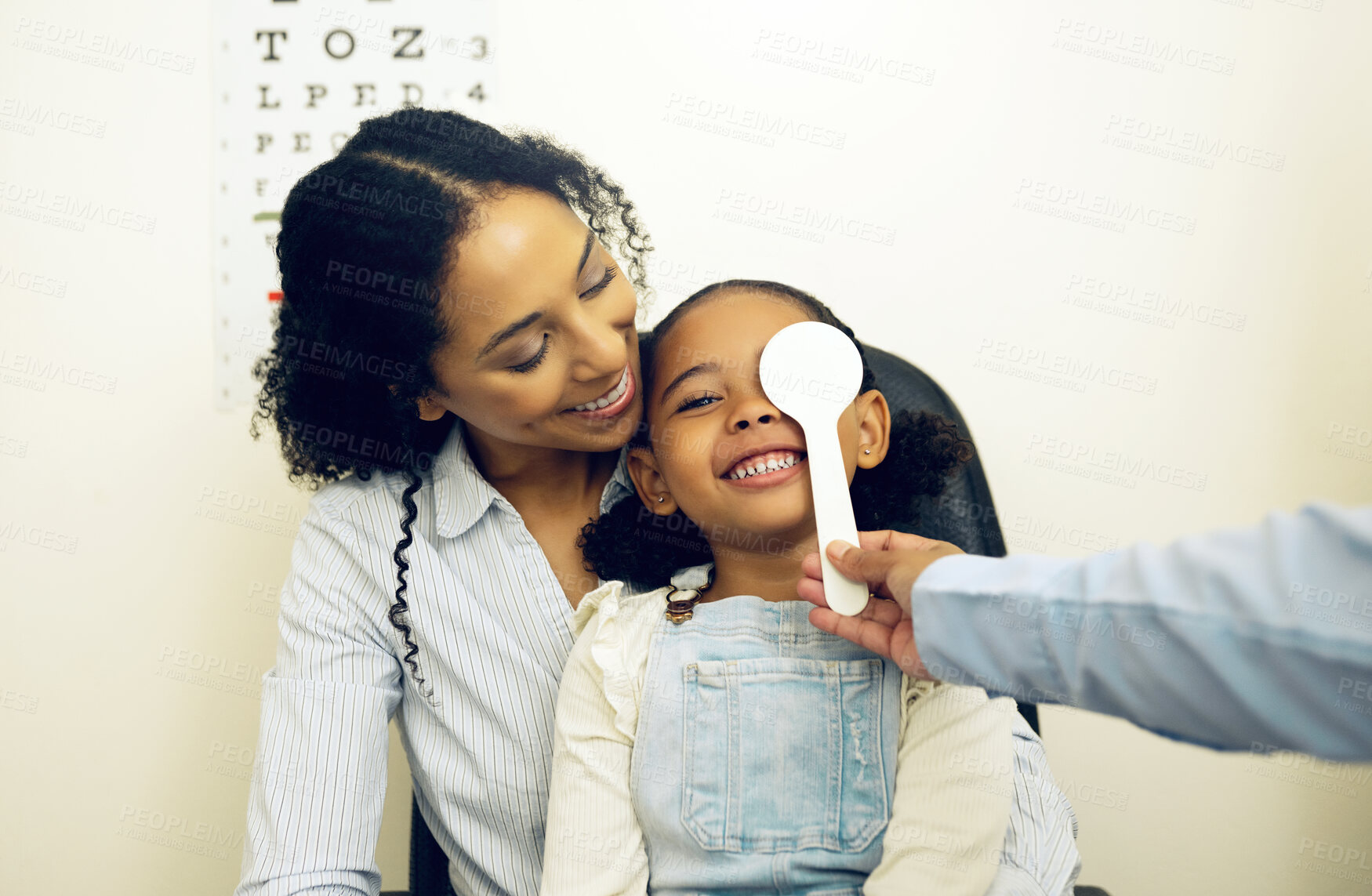 Buy stock photo Optometry, vision test and optometrist with child and mother at an eye care appointment for consultation. Health, medical and optician with young mom and girl kid patient with tool in optical clinic.