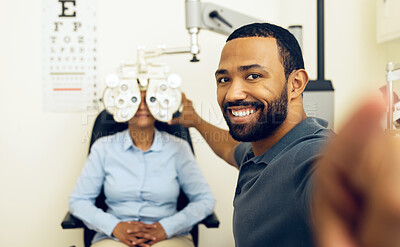 Buy stock photo Man, eye exam and phoropter with optometrist, portrait and check with lens, vision and wellness in clinic. Doctor, eyesight tools and machine for assessment, consultation and healthcare in hospital