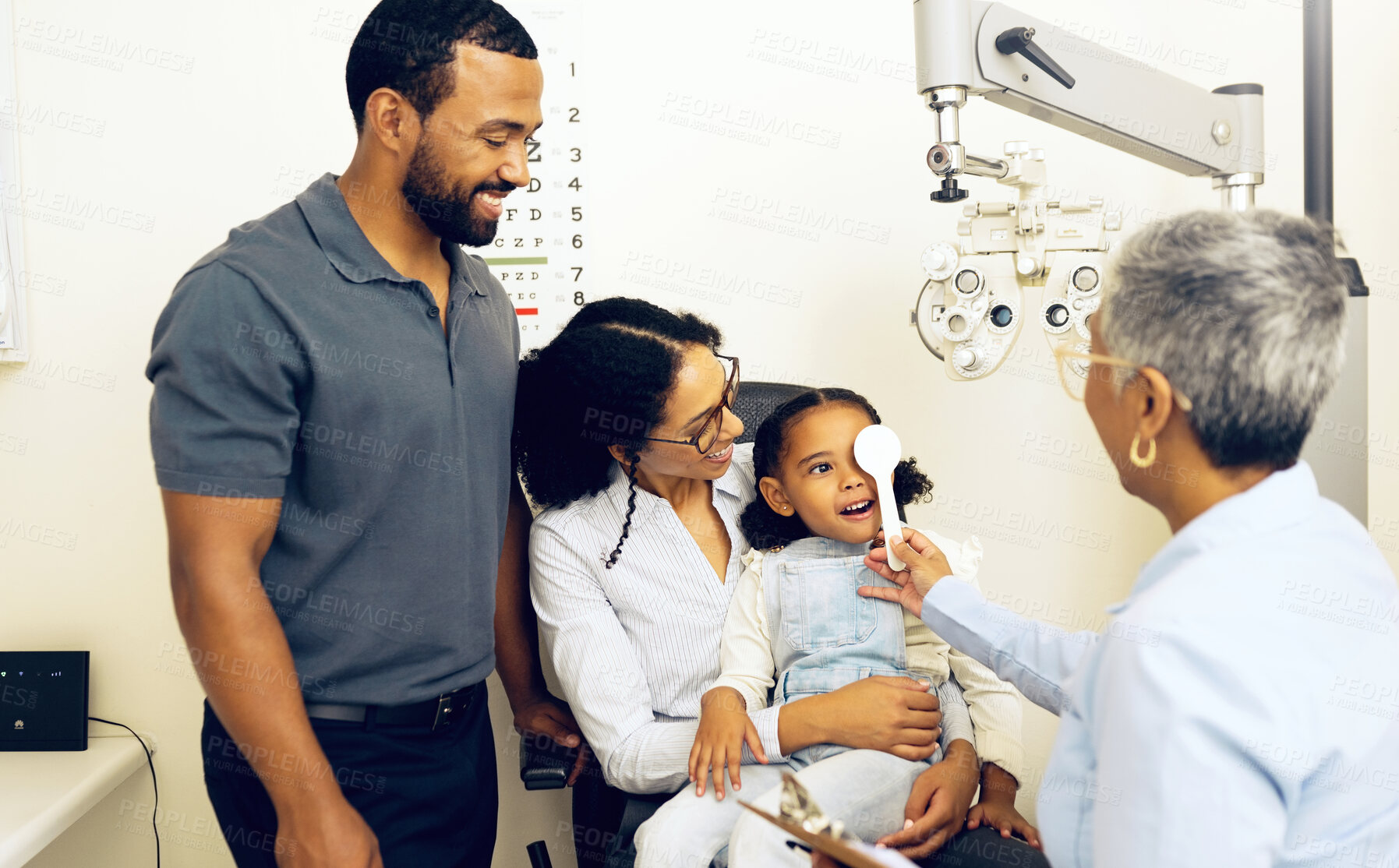 Buy stock photo Family, optometry and eye exam with a woman doctor in a clinic to see a patient for vision assessment. Mother, father and daughter at the optometrist for an appointment to test eyesight for children