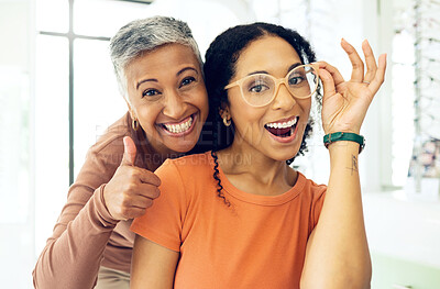 Buy stock photo Optometry, thumbs up or happy woman with glasses for vision in a retail optical or eyewear shop. Women, smile or biracial customer with new spectacles with a mature optometrist at optics clinic store