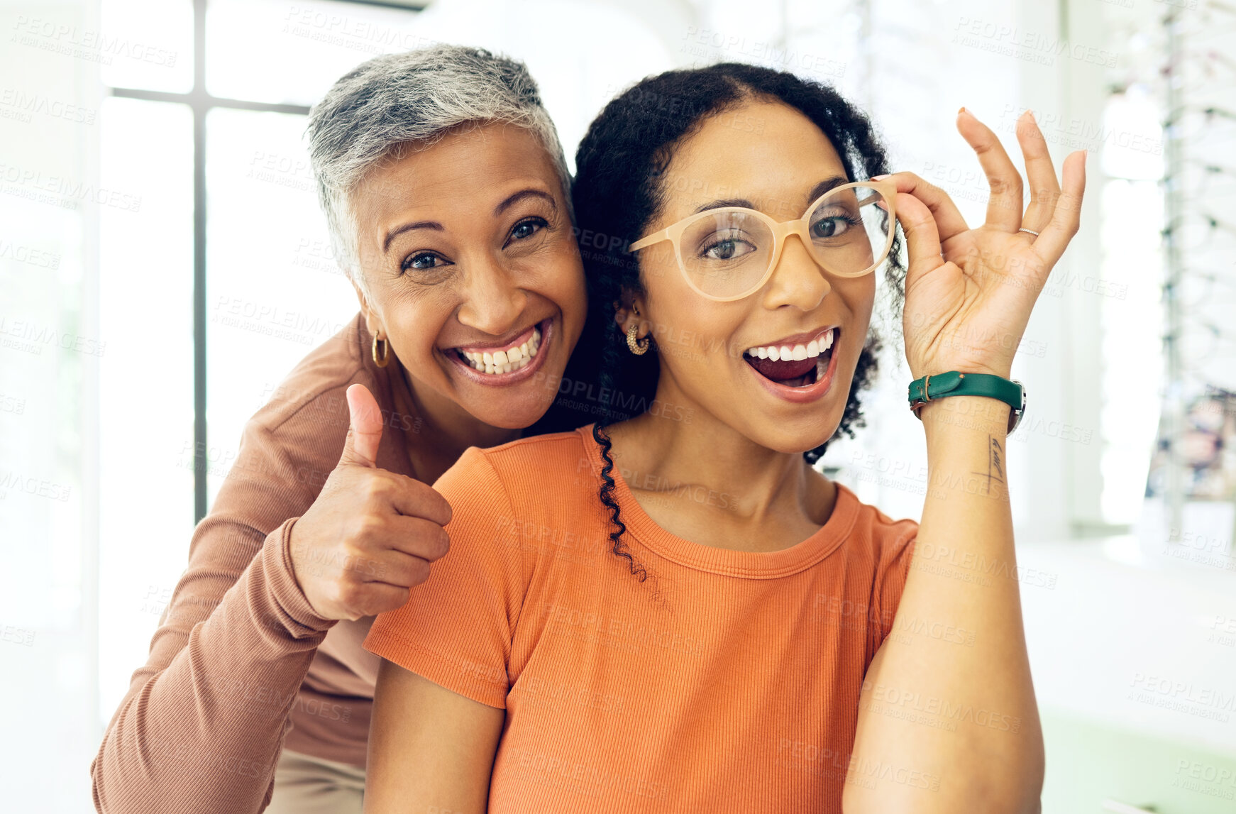 Buy stock photo Optometry, thumbs up or happy woman with glasses for vision in a retail optical or eyewear shop. Women, smile or biracial customer with new spectacles with a mature optometrist at optics clinic store