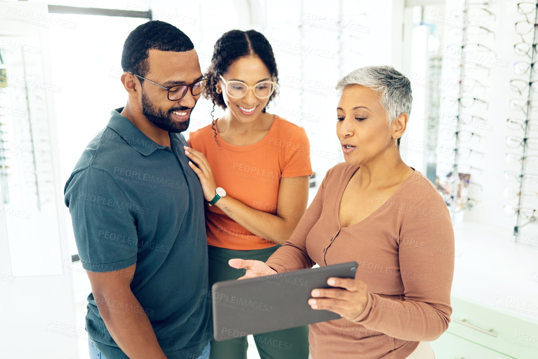 Buy stock photo Optometry, tablet and people shopping for glasses and on a website for online information. Lens, happy and a man and woman with an optometrist and technology for vision and eyewear consultation