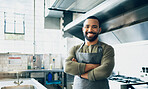 Happy man, chef and small business owner at restaurant for hospitality service, cooking or food in kitchen. Portrait of male person, employee or waiter smile in confidence for professional culinary