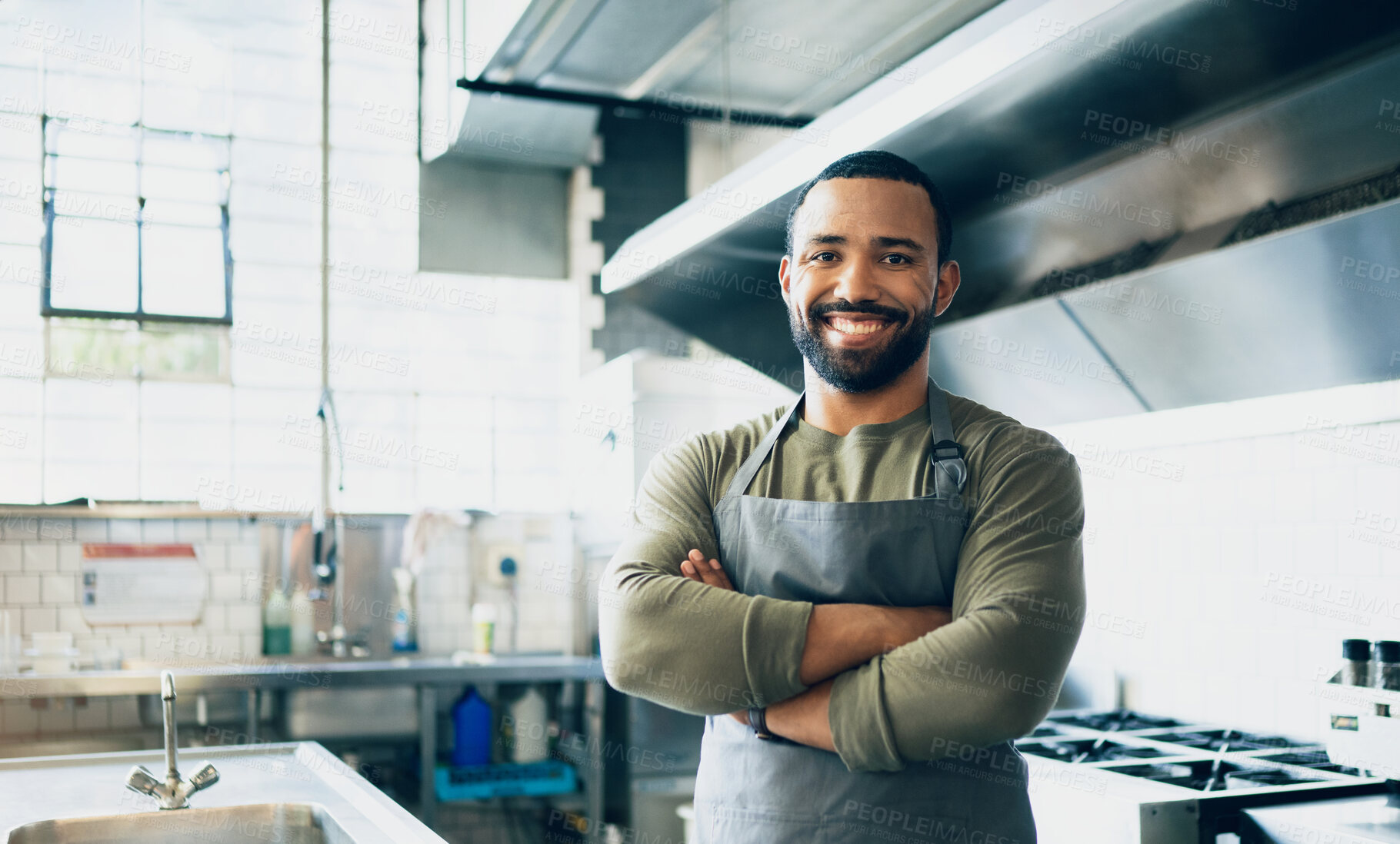 Buy stock photo Happy man, chef and small business owner at restaurant for hospitality service, cooking or food in kitchen. Portrait of male person, employee or waiter smile in confidence for professional culinary