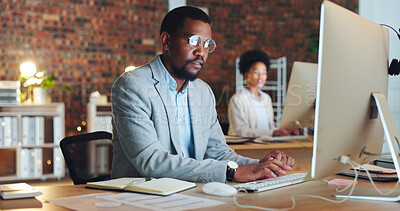 Buy stock photo Business man, office and computer for night planning, typing financial report and online research in accounting. Professional african accountant on desktop for email or analysis in startup workspace