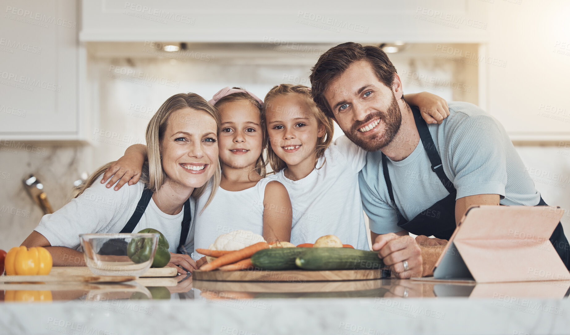 Buy stock photo Portrait, happy family and together in kitchen for cooking, dinner and vegan diet with hug. Man, woman and children with smile, quality time or bond by preparation, vegetables and recipe on tablet