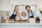 Smile, portrait and family cooking in kitchen together for bonding and preparing dinner, lunch or supper. Happy, love and girl children with vegetables or ingredients with parents for meal at home.