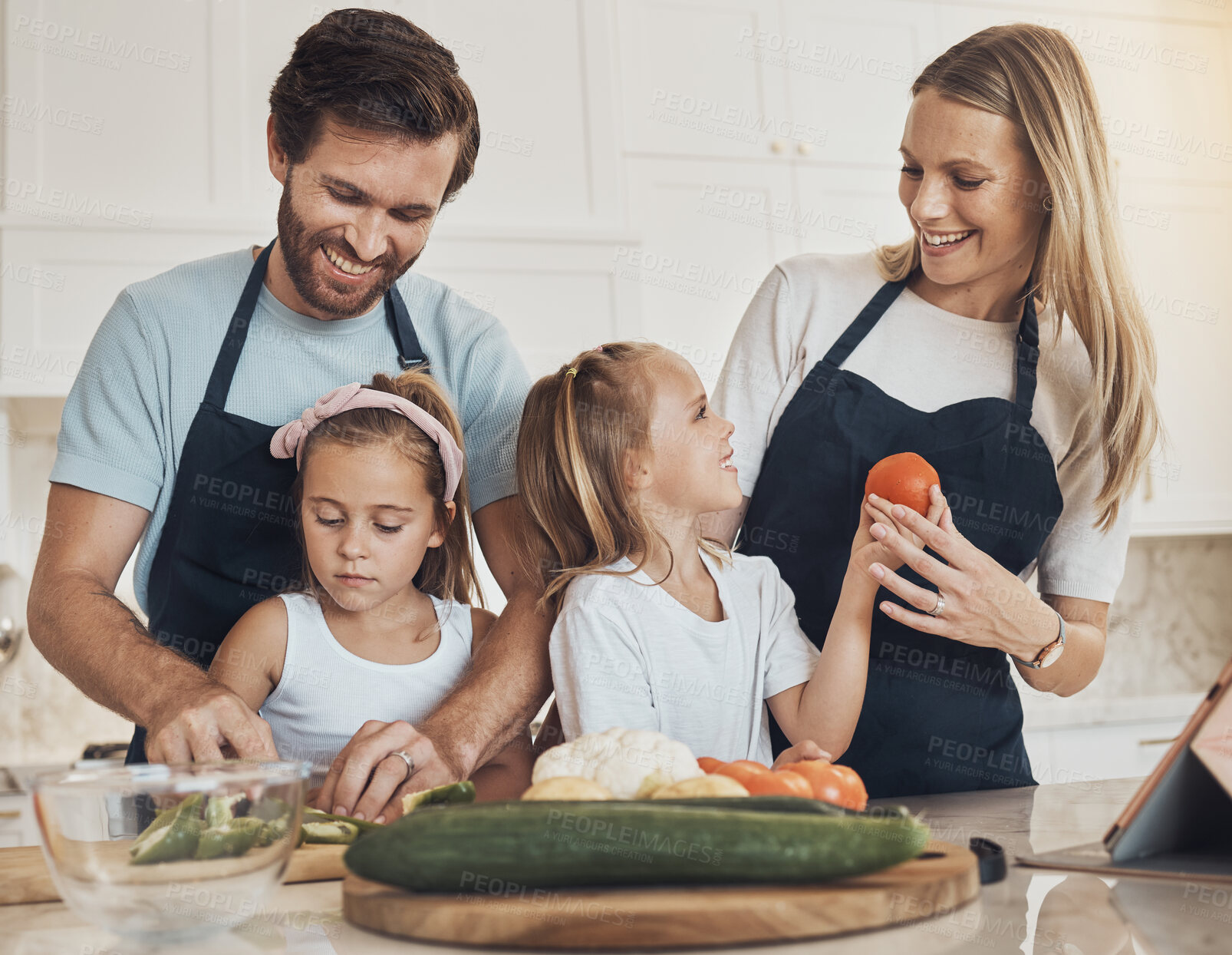 Buy stock photo Happy family, together and bond in kitchen by cooking with preparation, vegan diet and dinner. Children, parents and helping with meal, quality time and nutrition with smile learning and teaching