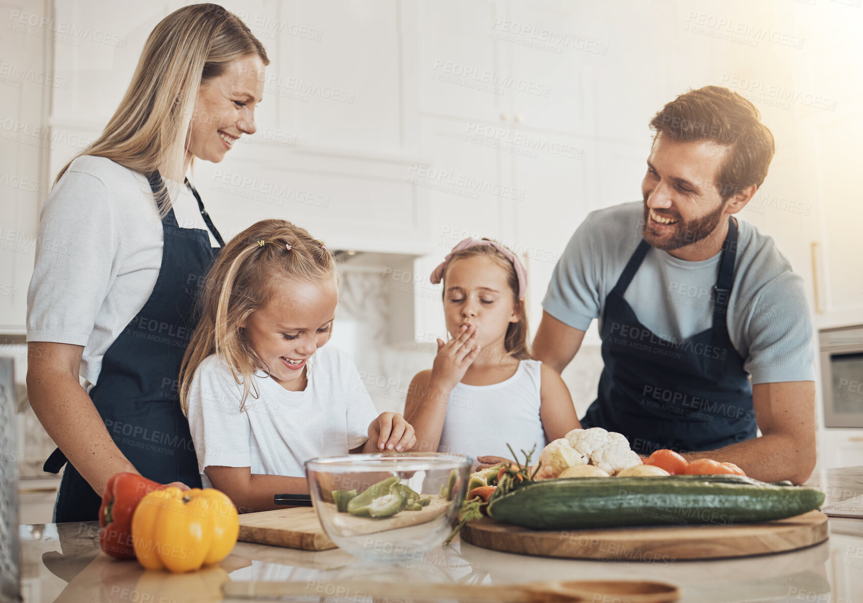 Buy stock photo Bonding, cooking and family in the kitchen together for preparing dinner, lunch or supper. Happy, smile and girl children cutting vegetables or ingredients with parents for a meal at modern home.