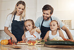 Kitchen, girls and parents with love, cooking and ingredients with support, healthy eating and food. Family, children and mother with father, kids and home with bonding, recipe and teaching with help