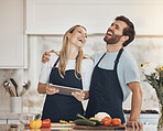 Cooking, funny or happy couple with tablet or food for a healthy vegan diet together at home. Smile, laugh or woman in kitchen to hug or bond with love or man learning a dinner recipe on online blog 