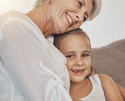 Buy stock photo Love, hug and girl child with grandmother on a sofa hug, bonding and relax in their home together. Family, care and face of kid with senior woman in a living room for babysitting or weekend visit