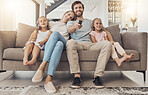 Happy family, relax and watching tv on living room sofa for entertainment or bonding together at home. Mother, father and children smile for fun streaming with remote for series or movie at the house