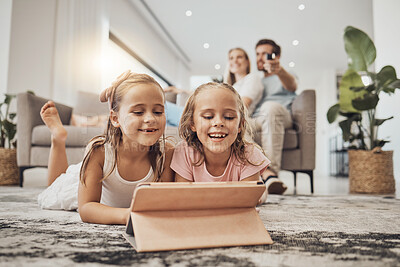 Buy stock photo Children, tablet and relax on carpet for home learning, watch video and happy games with parents in living room. Girl or sister on digital technology for virtual school, family movie or film on floor