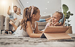 Happy kids on floor of living room with tablet, headphones and watching video, movie streaming or music. Digital game, online app and girl children relax on carpet together with fun in family home.