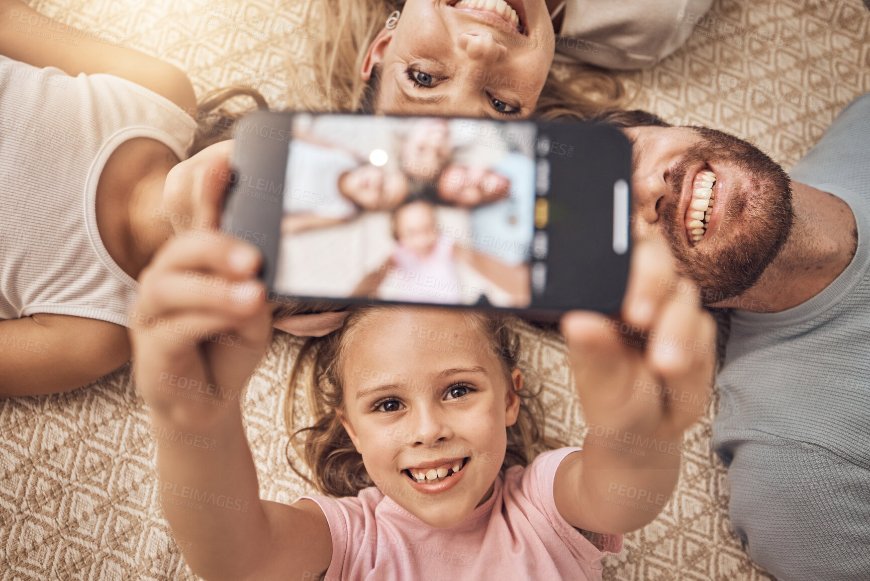 Buy stock photo Selfie, phone and top view of family on a floor with love, fun and smile for social media post at home. Smartphone, profile picture and girl children with parents in a living room for weekend memory