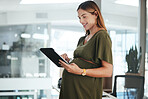 Tablet, reading and pregnant business woman in office doing research for information on internet. Maternity, smile and female designer from Canada with pregnancy working on digital tech in workplace.