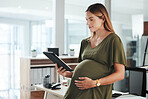 Tablet, happy and pregnant business woman in office reading research information on internet. Maternity, smile and female designer from Canada with pregnancy work on digital technology in workplace.