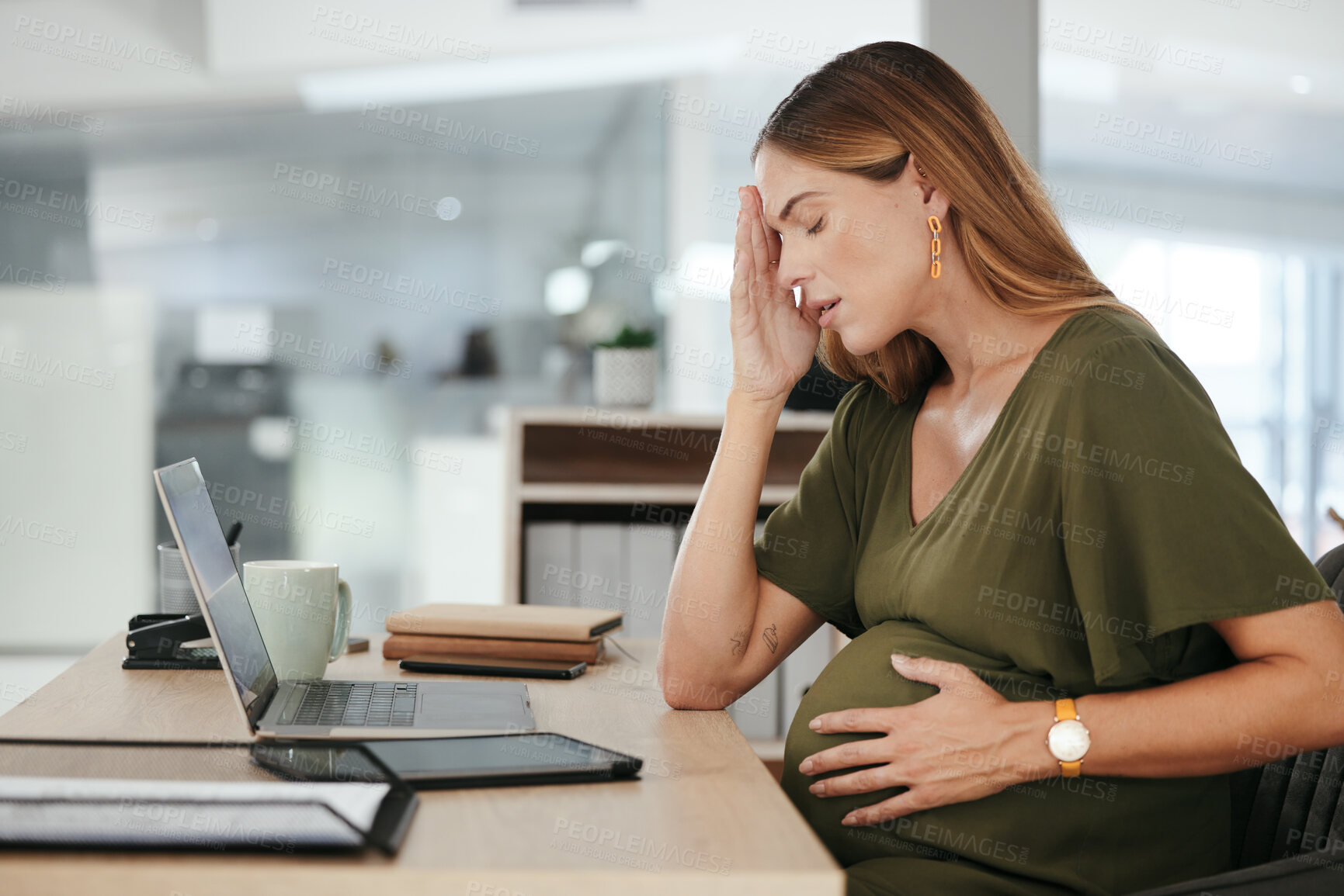 Buy stock photo Pregnant, woman and headache in office with tired, burnout and relax with eyes closed at desk or table. Person, pregnancy or hand on stomach for risk, anxiety or stress at professional company or job