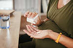 Drugs in hand, pregnant woman with health and supplement for baby, prescription and prenatal vitamins at desk. Medicine at work, healthcare and pharmaceutical pills for healthy pregnancy and iron