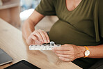 Pills, container and pregnant woman with health and supplement for baby, prescription and prenatal vitamins at desk. Medicine at work, healthcare and pharmaceutical drugs for healthy pregnancy