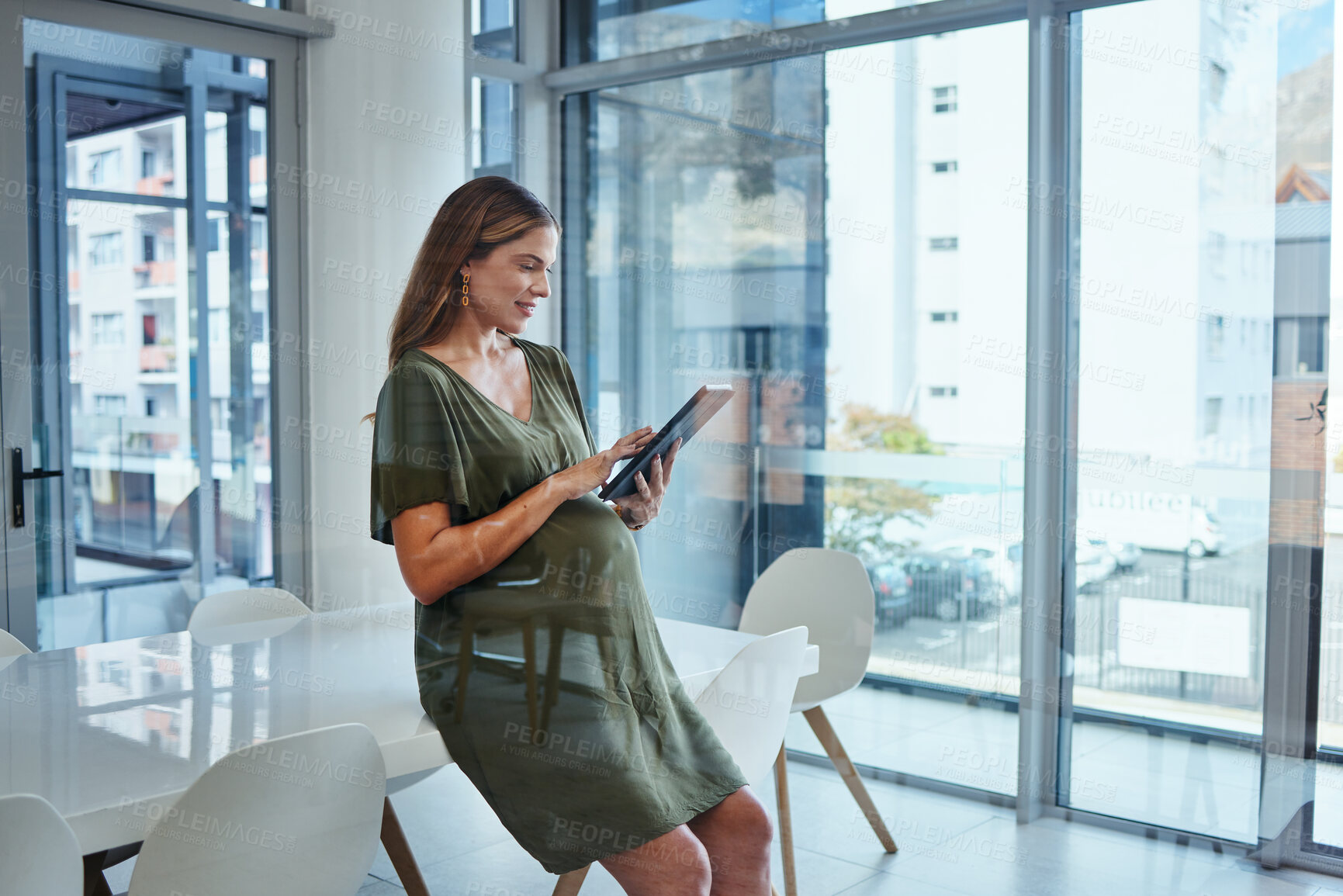 Buy stock photo Woman, reading and tablet in office for business, networking or ideas for marketing or sitting on table. Person, touchscreen and happiness at work for communication, conversation or web and pregnant