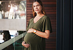 Portrait, balcony and a pregnant business woman at her office with glass at the start of her maternity leave from work. Company, belly and pregnancy with a happy young employee at the workplace