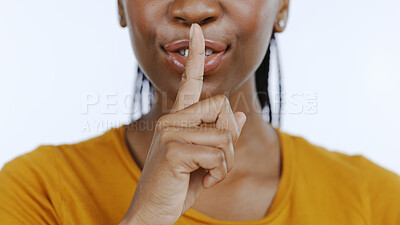 Buy stock photo Secret, finger to lips and black woman in studio for privacy, confidential information and face on white background. Mouth zoom, quiet and silence gesture with emoji, gossip or whisper with news 