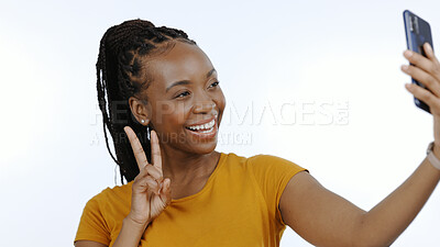 Buy stock photo Black woman, peace sign and selfie for social media, influencer content creation or blog in studio. Happy young person with smile and emoji for profile picture or photography on a white background