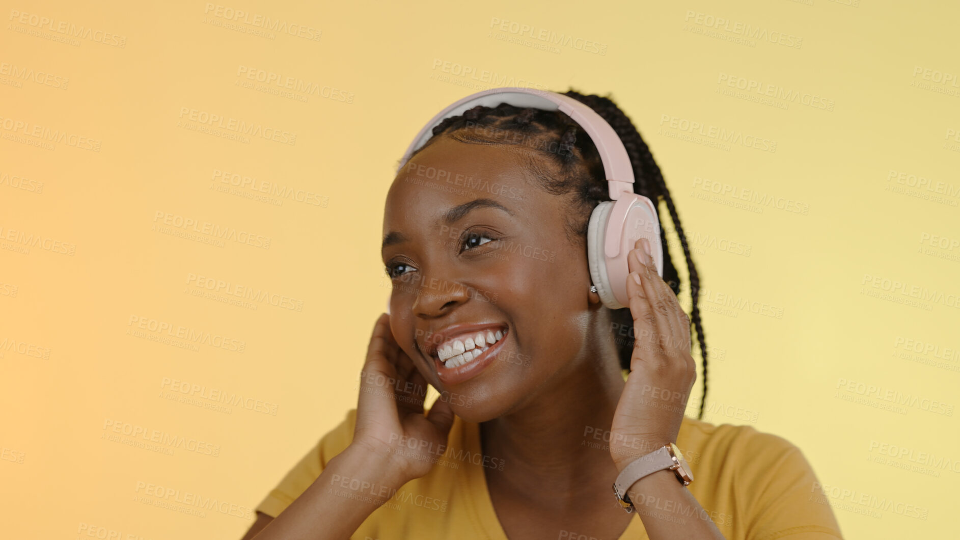 Buy stock photo Smile, headphones and black woman with a smartphone, listening and excited on a yellow studio background. African person, model or girl with a headset, joy and cellphone with audio or streaming music