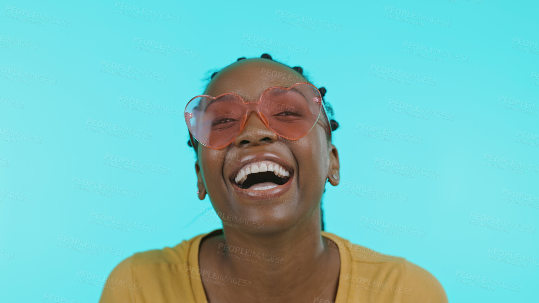 Buy stock photo Face, funny and black woman with heart glasses, relax and freedom on a blue studio background. Portrait, African person or happy model with funky eyewear, trendy or silly with comedy joke or joy