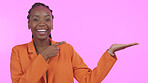 Black woman, branding and pointing for advertising in studio on blank mock up space for product placement. Portrait, happy or person with promotion for business, marketing or offer on pink background
