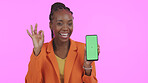 Business woman, phone green screen and okay for website information, marketing space and success on pink background. Portrait of African person with mobile mockup and yes emoji for contact in studio