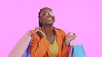 Woman, shopping bag and sunglasses for fashion sale, discount and giveaway prize or competition in studio. Portrait of african person or excited customer with gift or funky style on pink background