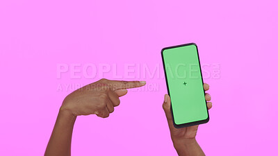 Buy stock photo Hands, pointing at green screen and smartphone, advertising mockup with app and ads on pink background. Tracking marker, person in studio with online information for website and tech marketing