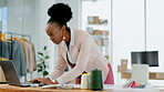 Black woman, laptop and fashion designer in small business, strategy or ideas at boutique store. African female person working on computer in logistics for clothing, planning or schedule delivery