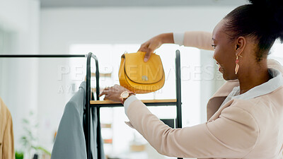 Buy stock photo Fashion, bag and a black woman designer in a retail store as a small business owner or startup entrepreneur. Smile, accessories and a happy young employee in a shop at the mall for boutique sales