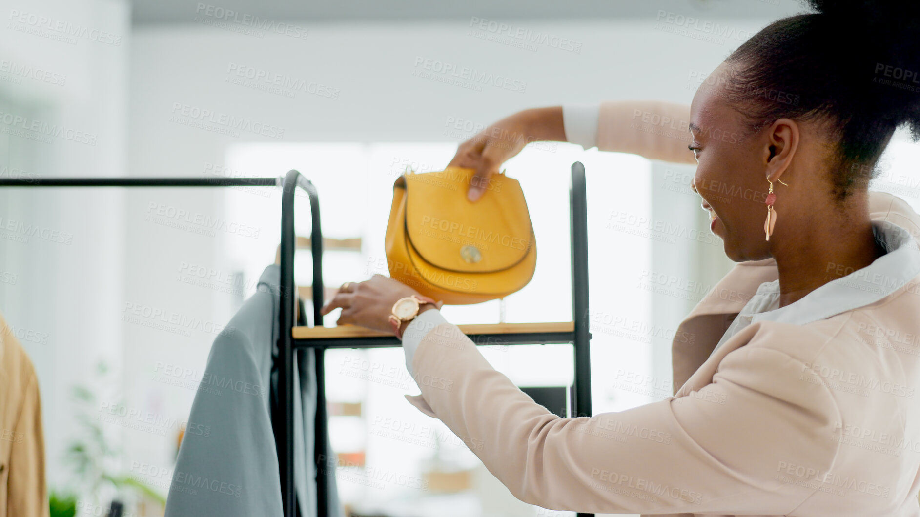 Buy stock photo Fashion, bag and a black woman designer in a retail store as a small business owner or startup entrepreneur. Smile, accessories and a happy young employee in a shop at the mall for boutique sales