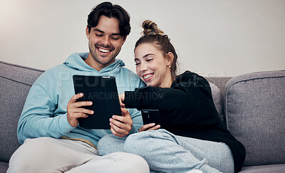 Buy stock photo Couple, phone and tablet with laugh on sofa for social media, internet scroll and funny meme with relax. People, man or woman on couch with smartphone and touchscreen for technology and web streaming