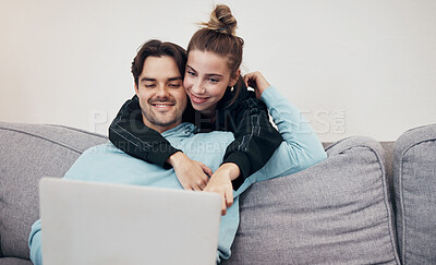 Buy stock photo Love, hug and couple on a sofa with laptop for streaming, movie or social media in their home. Tech, search and people embrace in a living room online for internet, browsing or entertainment in house