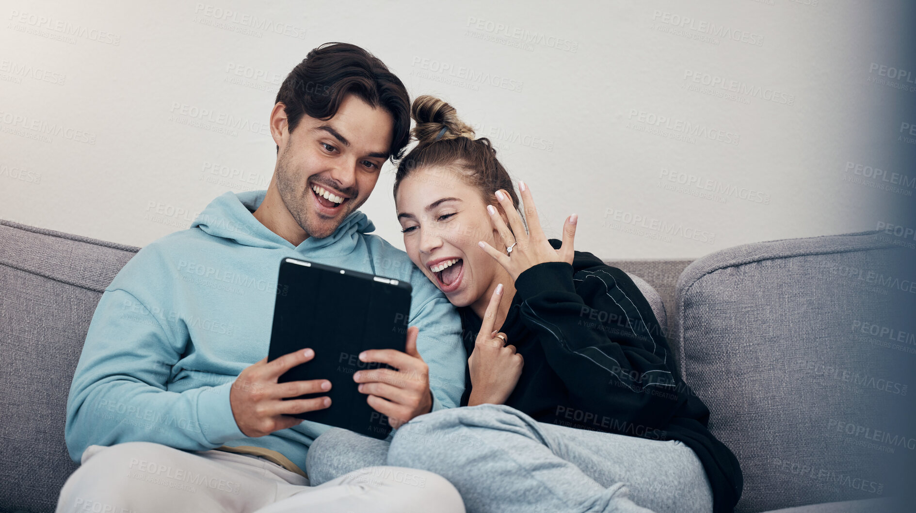 Buy stock photo Man, woman and video call for engagement ring with happiness on sofa in living room of home. People, couple and couch with tablet and excited face for commitment goal and social media announcement