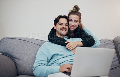 Buy stock photo Portrait, hug and couple on a sofa with laptop for streaming, movie or social media in their home. Face, love and people relax in a living room online for internet, browsing or entertainment in house