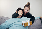 Surprise, gift and couple on a sofa for birthday, celebration or anniversary at home. Gift, box and people in a living room with guess game for present, romance or congratulations gesture in a house
