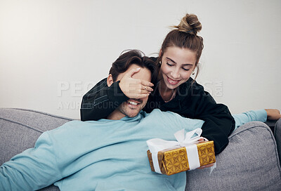 Buy stock photo Surprise, gift and couple on a sofa for birthday, celebration or anniversary at home. Gift, box and people in a living room with guess game for present, romance or congratulations gesture in a house